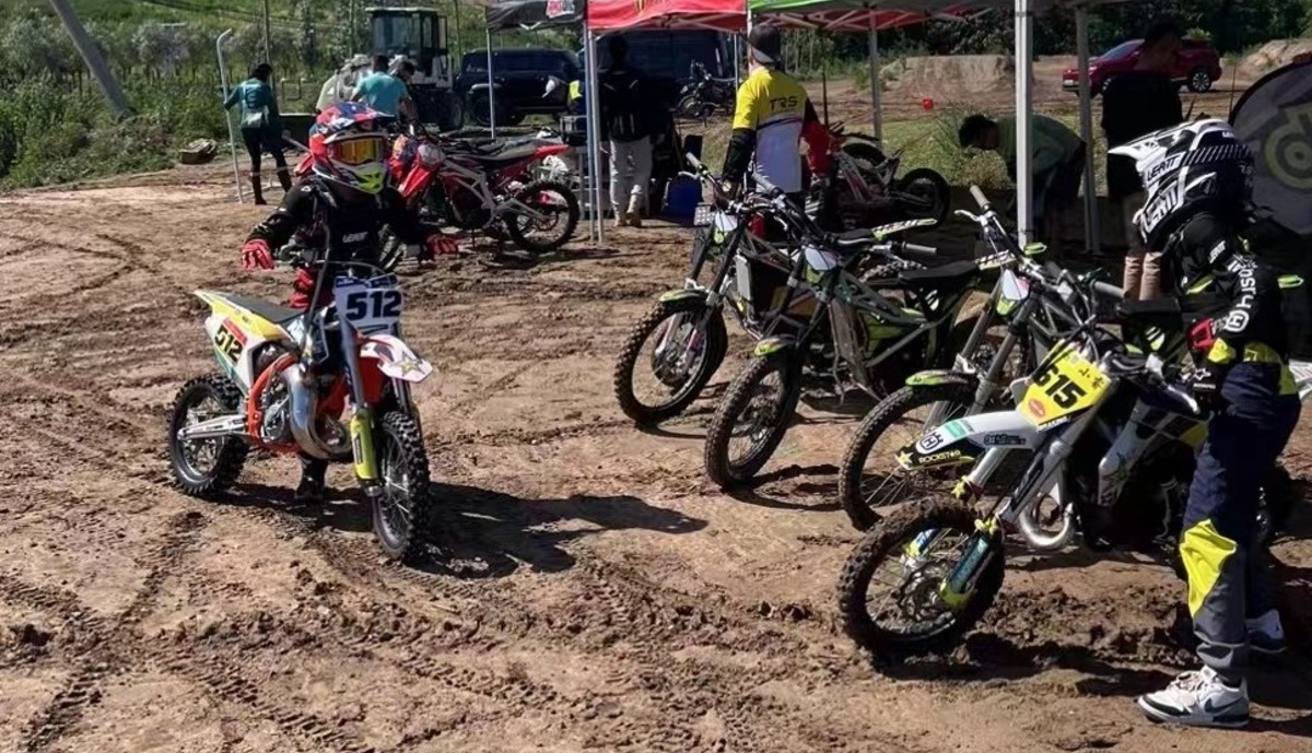 Confident young dirt bike rider waiting for Match to begin
