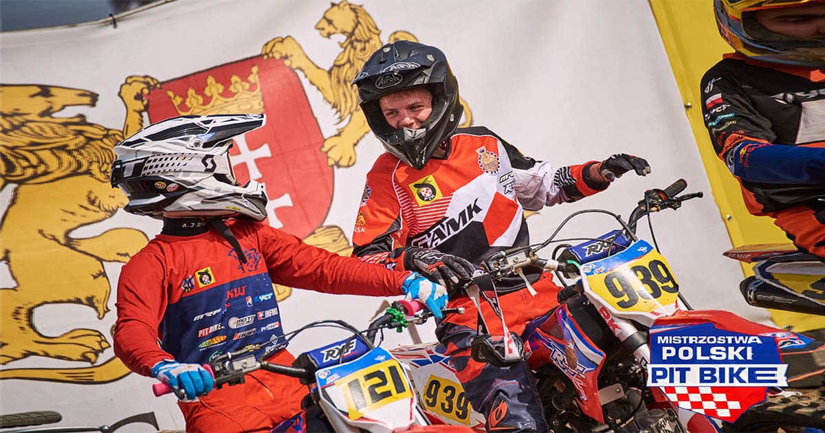 Two dirt bike riders chatting and sharing experience in an event
